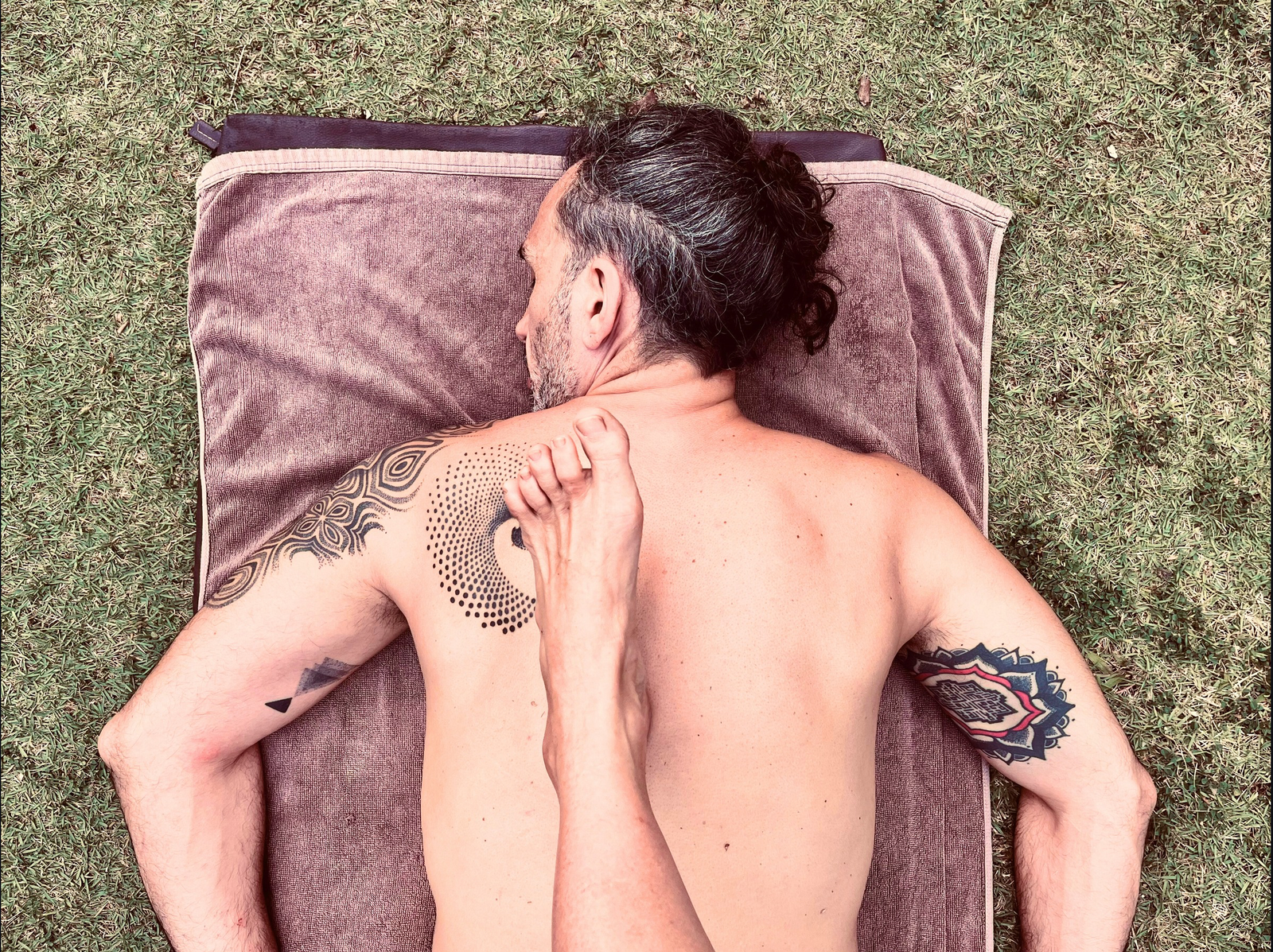 Ayurvedic walking massage with the therapist massaging the client’s back.